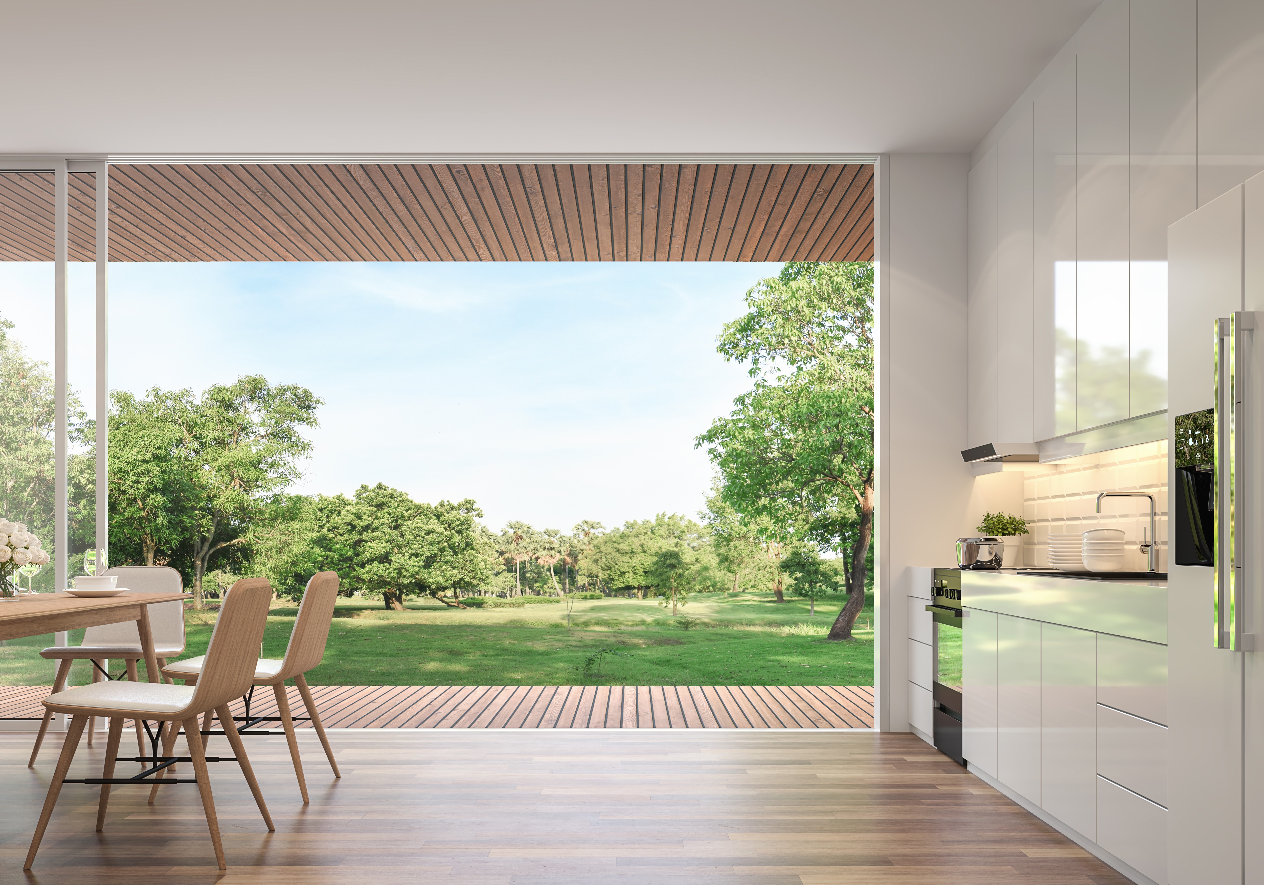 Modern dining room 3d render.Rooms have wooden floors, decorated with wooden furniture and a glossy white kitchen counter with large open doors. Overlooking the terrace and large garden.