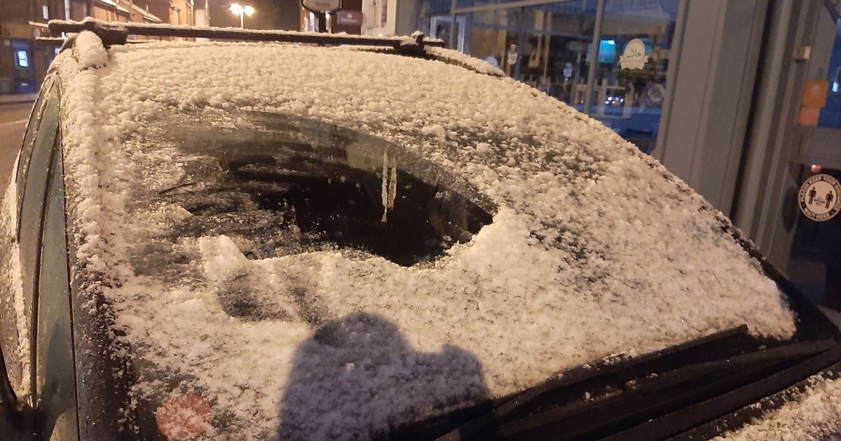 Police stop snow-covered car from driving along road in China